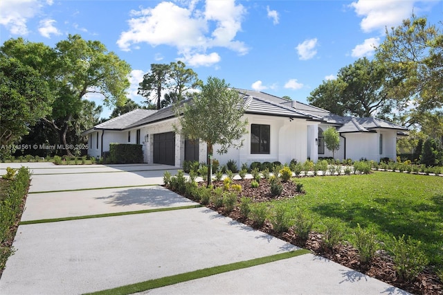 view of front of home with a garage and a front yard