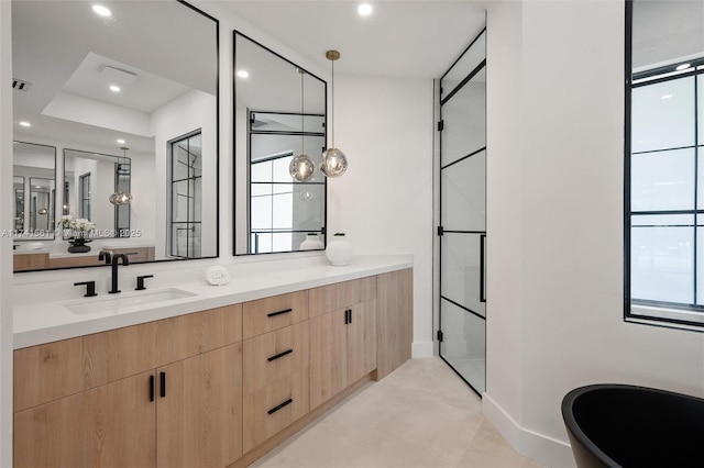 bathroom with vanity and a shower with shower door