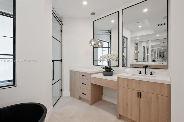 bathroom featuring walk in shower and vanity