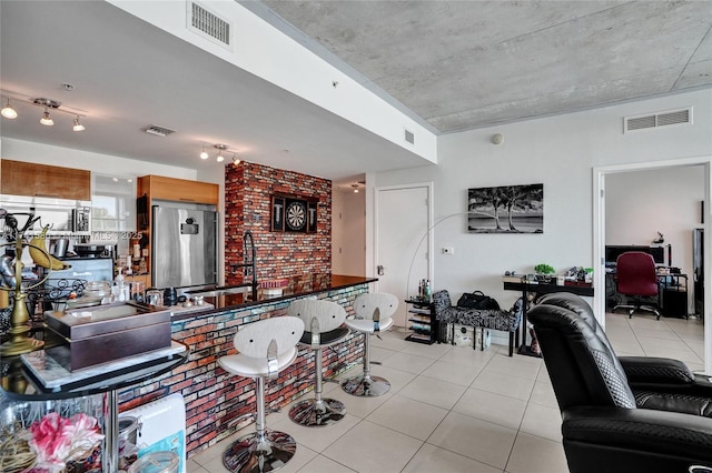 interior space featuring sink and light tile patterned floors