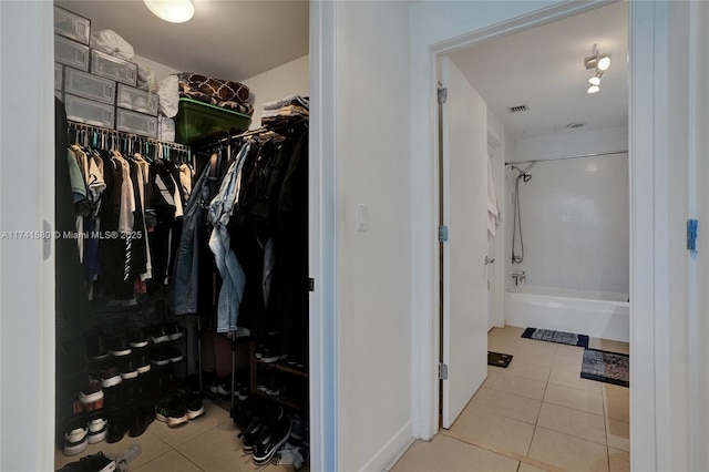 spacious closet featuring light tile patterned flooring