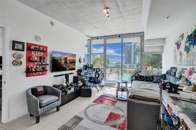 living room featuring expansive windows and light tile patterned flooring