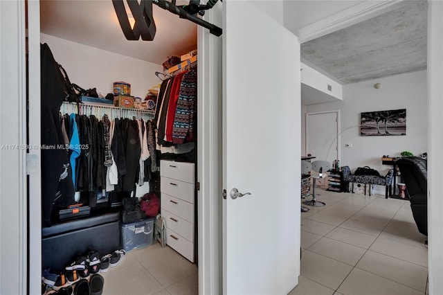 spacious closet with light tile patterned floors