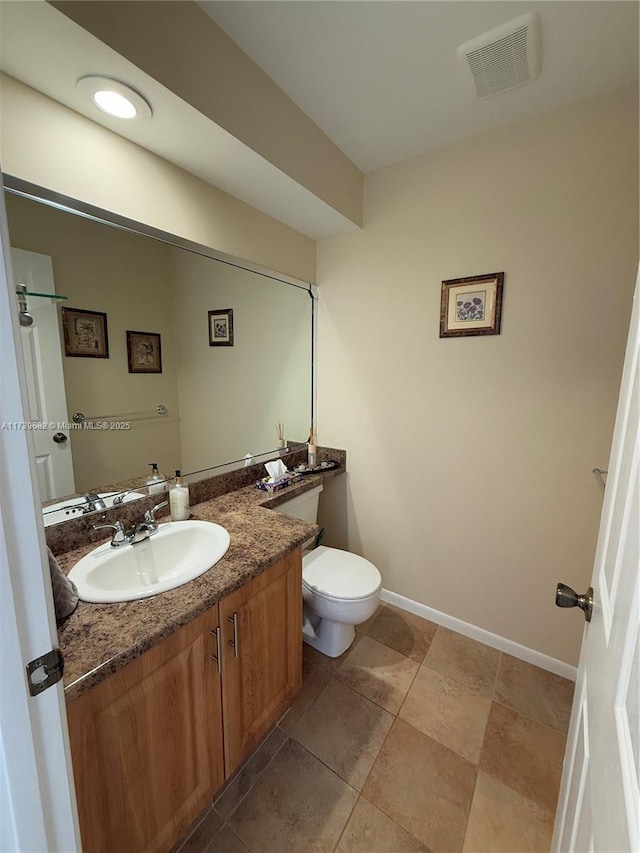 bathroom with vanity, tile patterned floors, and toilet