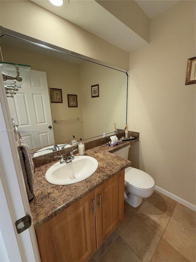 bathroom featuring vanity, toilet, and tile patterned flooring