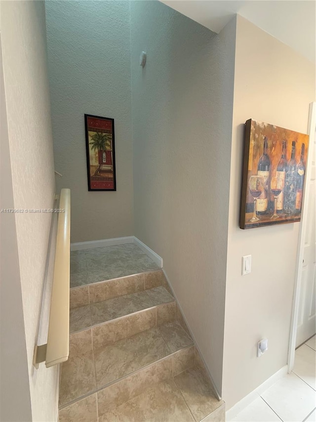 stairs featuring tile patterned floors