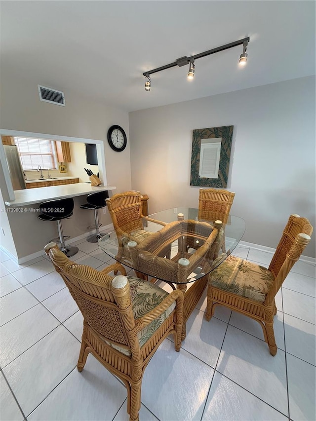 tiled dining space featuring sink