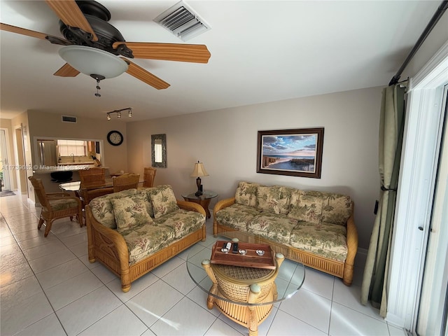 tiled living room featuring ceiling fan and rail lighting