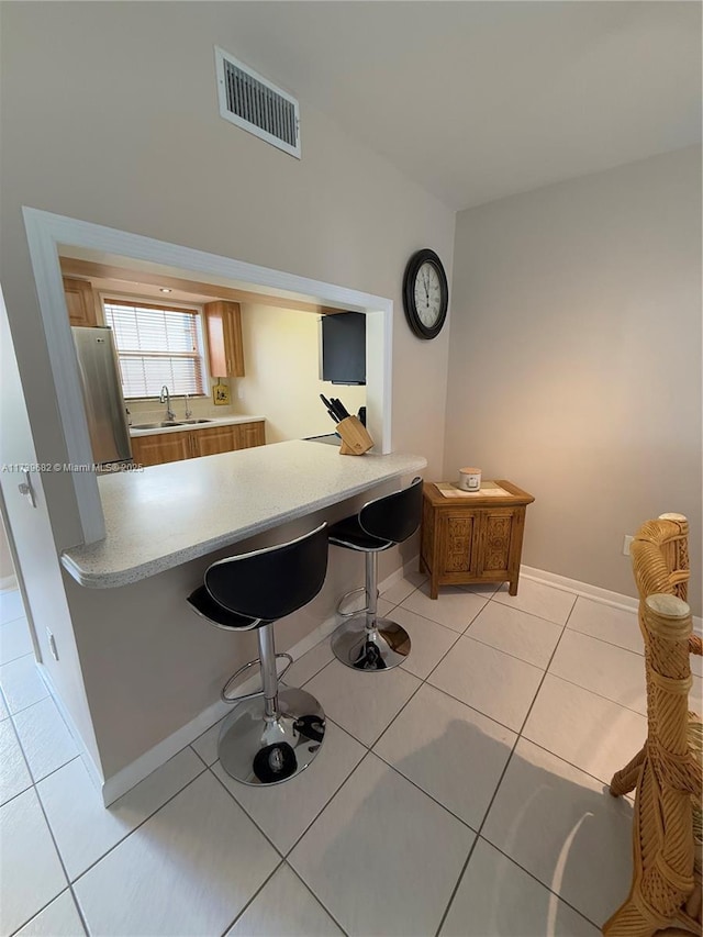 unfurnished office featuring sink and light tile patterned flooring