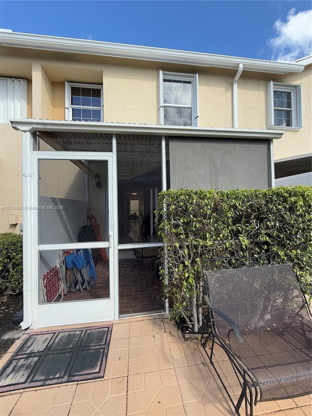 back of house featuring a sunroom