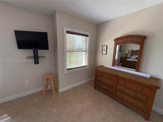 tiled bedroom with a textured ceiling