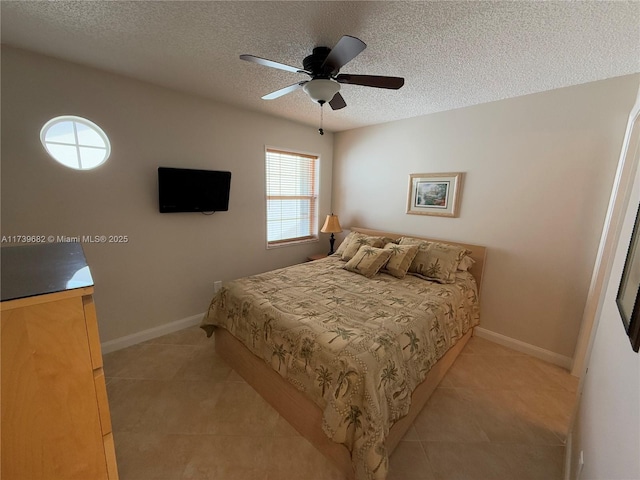 tiled bedroom featuring ceiling fan and a textured ceiling