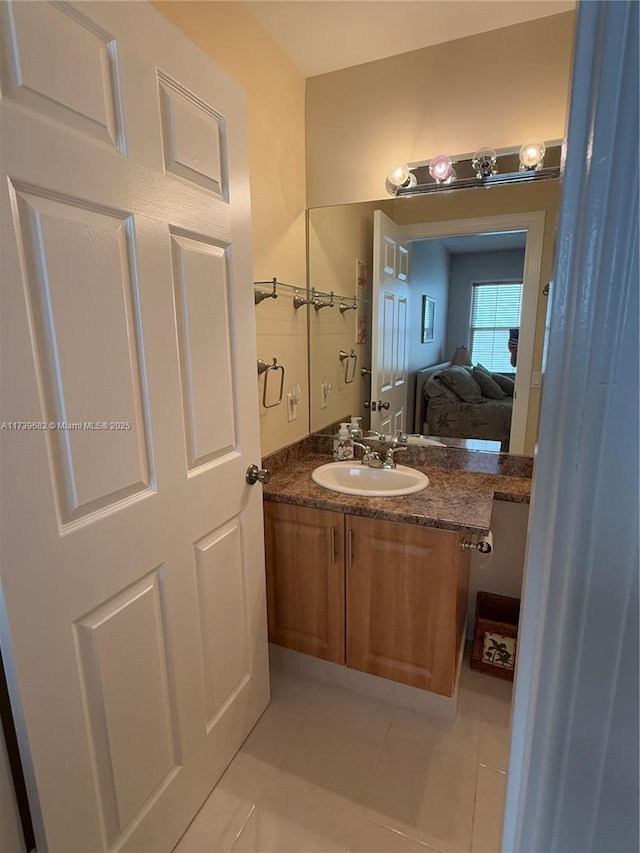 bathroom featuring tile patterned flooring and vanity