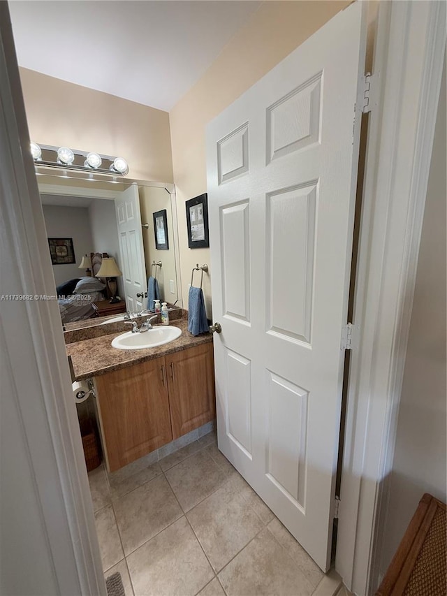 bathroom with tile patterned floors and vanity