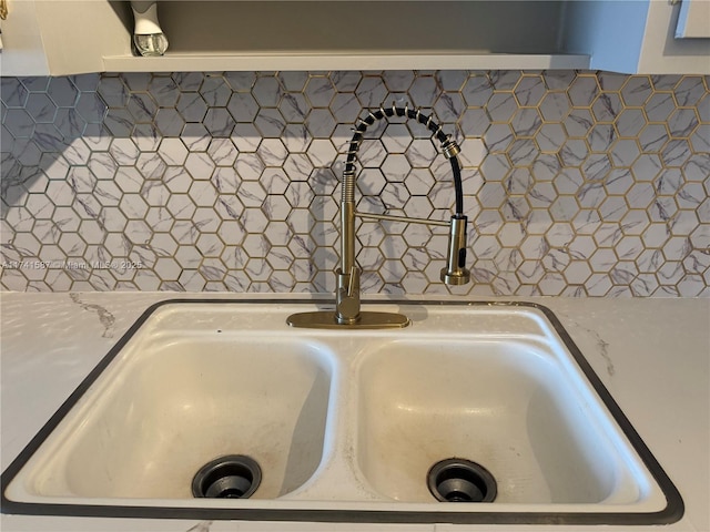 interior details with white cabinetry and sink