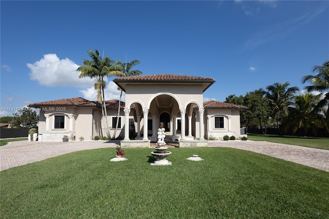 mediterranean / spanish-style home featuring a front lawn