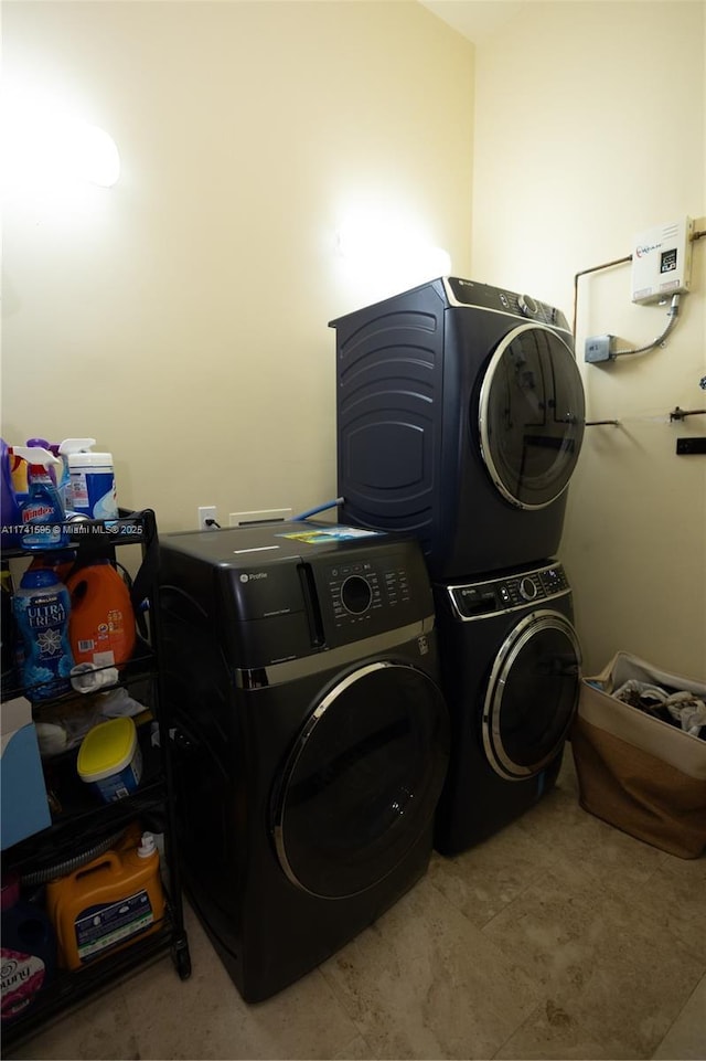 clothes washing area featuring stacked washer and clothes dryer