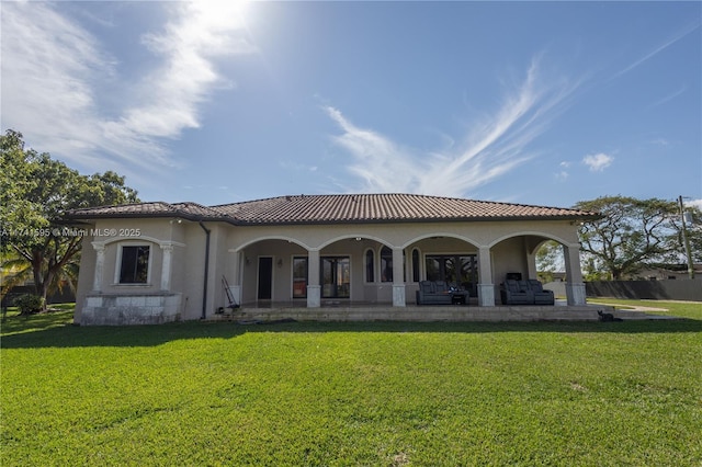 back of property with a yard and a patio area