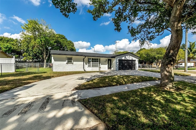 single story home featuring a garage and a front lawn