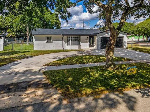 view of front of property featuring a garage and a front lawn