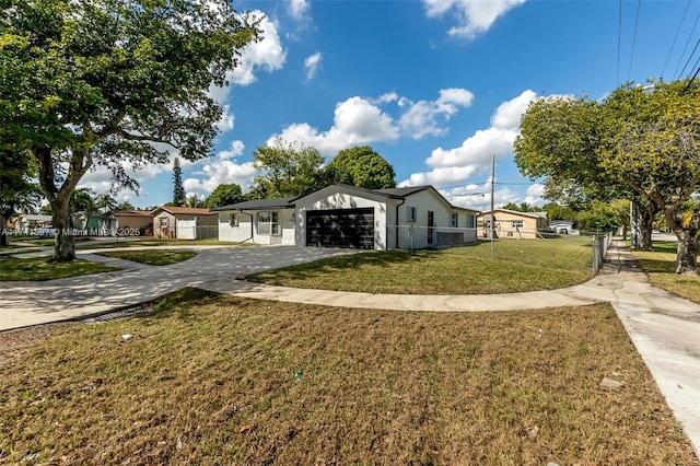 view of front facade with a garage and a front lawn