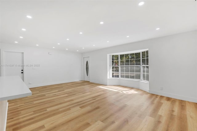 unfurnished living room with light wood-type flooring