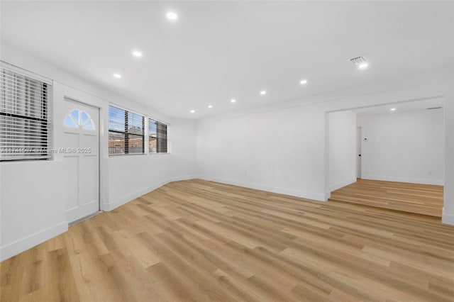 unfurnished room with light wood-type flooring