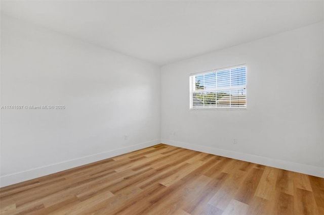 unfurnished room with light hardwood / wood-style floors