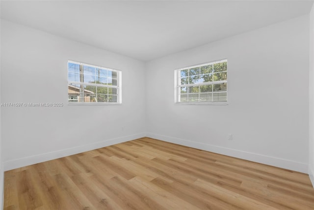 spare room featuring light hardwood / wood-style flooring