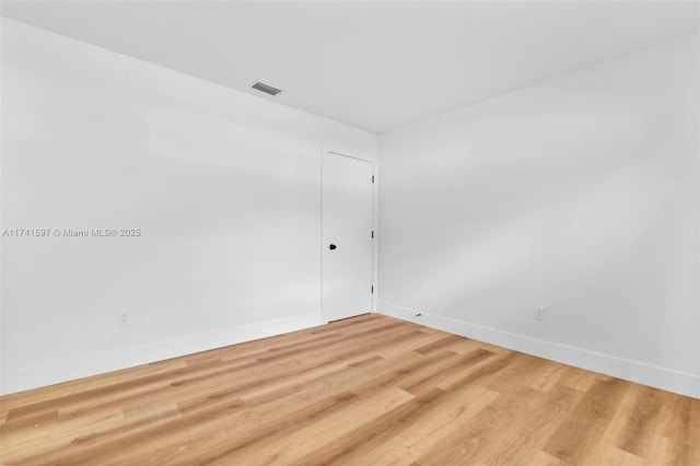 unfurnished room with hardwood / wood-style flooring