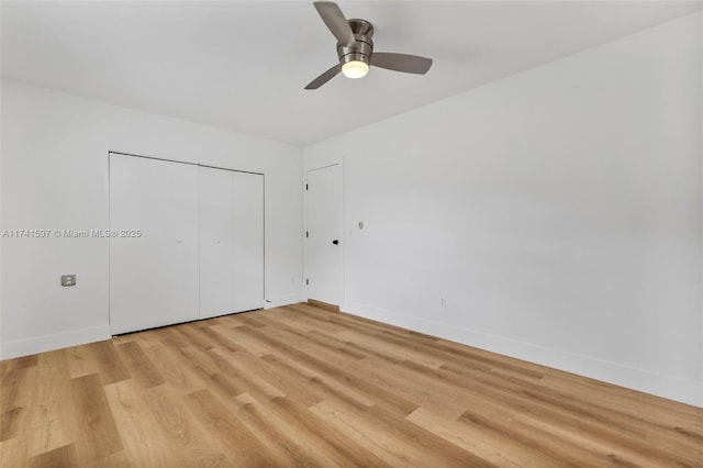 unfurnished bedroom with light hardwood / wood-style floors, a closet, and ceiling fan