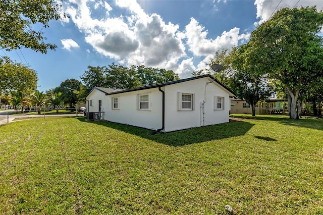 view of side of home featuring a yard