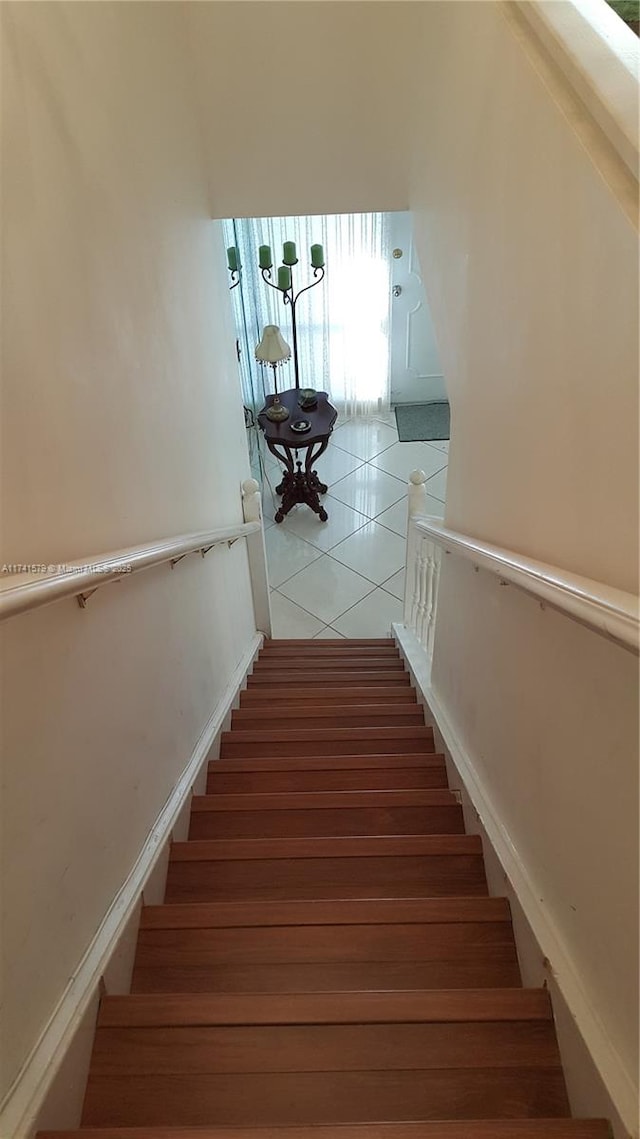 stairway with tile patterned flooring