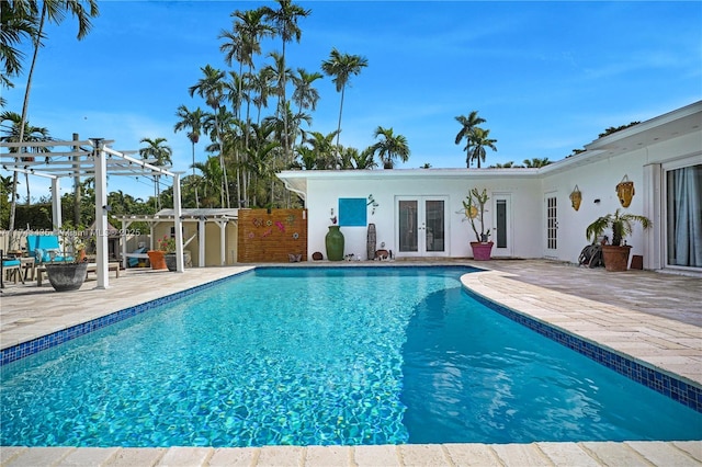 view of pool featuring french doors, a patio, and a pergola