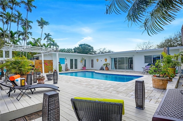 view of pool featuring a pergola, french doors, and a deck