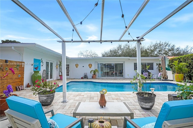 view of swimming pool featuring a lanai and a patio