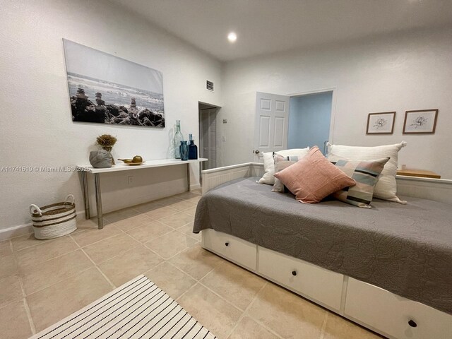 bedroom featuring light tile patterned floors