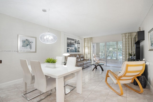 tiled dining area with a chandelier