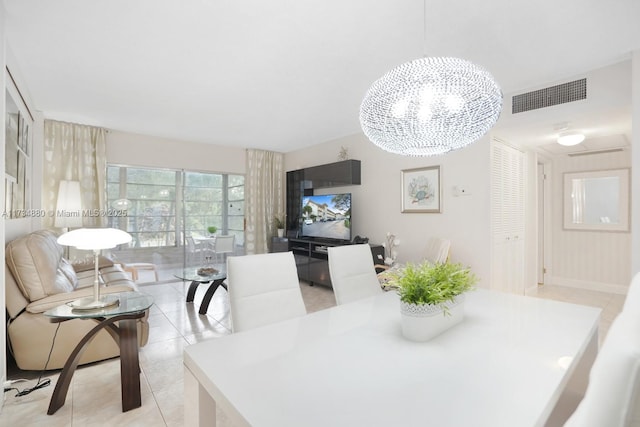 tiled dining space with a chandelier