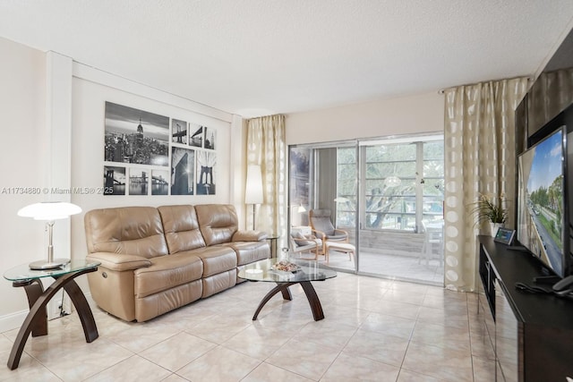 tiled living room featuring a textured ceiling