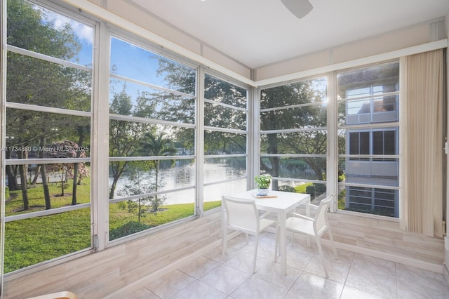 unfurnished sunroom featuring a water view