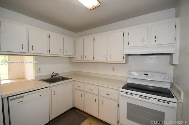 kitchen with light tile patterned flooring, white appliances, sink, and custom exhaust hood