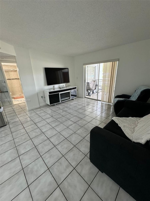 living room with light tile patterned flooring and a textured ceiling