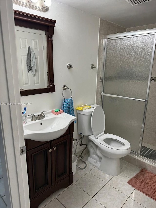 bathroom featuring tile patterned flooring, vanity, and an enclosed shower