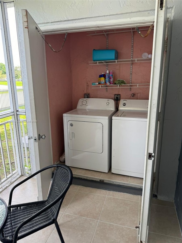 laundry room with light tile patterned flooring and washer and dryer