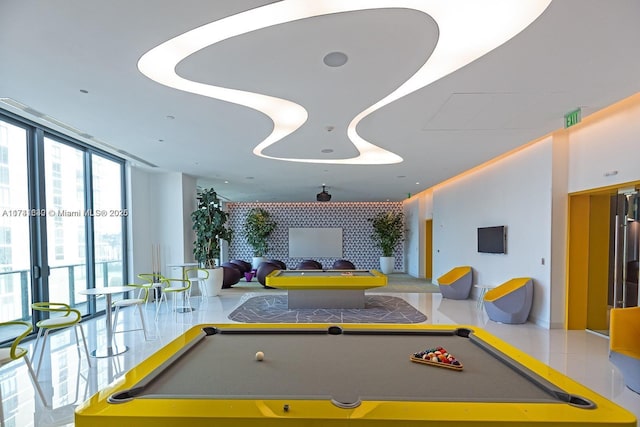 recreation room featuring expansive windows and tile patterned floors