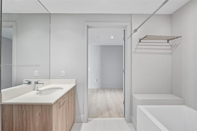 full bath featuring a tub to relax in and vanity