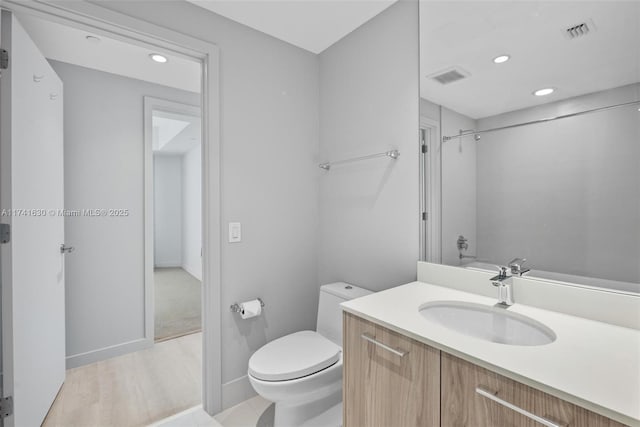 bathroom with recessed lighting, visible vents, vanity, and toilet