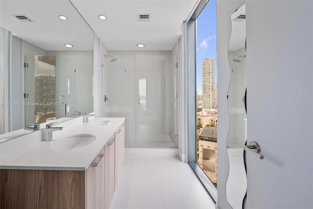 bathroom featuring a stall shower, visible vents, and a sink