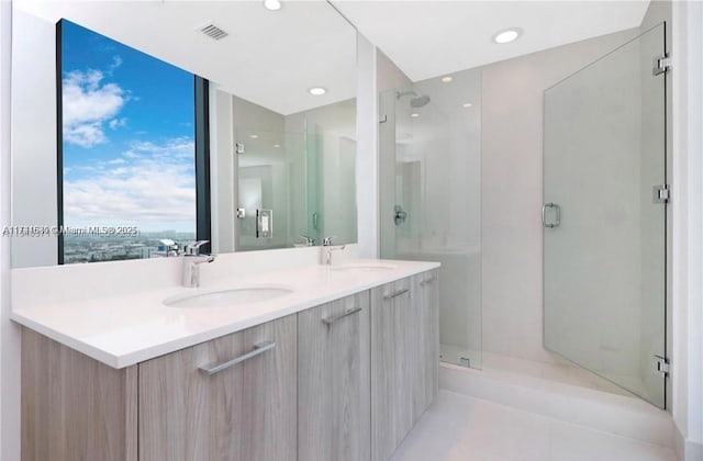 bathroom with a shower with door and vanity